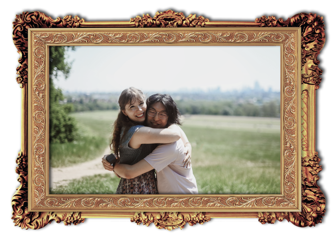 A framed picture of Joon and Annie embracing at Hampstead Heath on a sunny day.